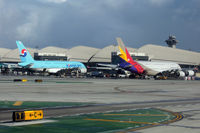HL7613 @ KLAX - Direct competitors next to each other at TBIT - by Micha Lueck