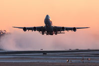 B-LJK @ CYYZ - Departing runway 05 at Toronto Pearson at sunset, blowing clouds of snow behind it - by BlindedByTheFlash