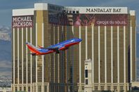 N757LV @ KLAS - Southwest Airlines, is here climbing out Las Vegas(KLAS) in front of the Mandalay Bay Hotel - by A. Gendorf