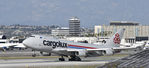 LX-VCV @ KLAX - Departing LAX on 25L - by Todd Royer