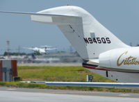 N945QS @ KSJC - A 1997 Cessna Citation X (NetJets Aviation) taxing out of the Atlantic FBO getting ready to depart while a Horzion/Alaska Dash-8 lands at San Jose International Airport, CA. - by Chris Leipelt