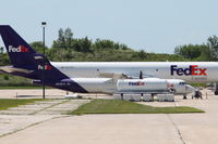 N810FX @ KCID - Parked at the FedEx ramp, hiding behind a fuel tank - by Glenn E. Chatfield