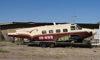 VH-NWB @ CVH - A 1960 Beech G18S sitting on an old trailer never to fly again at Hollister Municipal Airport, Hollister, CA. - by Chris Leipelt