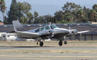 N7289R @ KRHV - Locally-based 1975 Beechcraft Baron 55 departing runway 31R at Reid Hillview Airport, San Jose, CA. - by Chris Leipelt