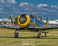 N4708C @ KOSH - A gleamingly polished AT-6F Texan N4708C taxis out past Warbird Alley at Oshkosh. - by Greg Drawbaugh