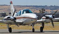 N1BF @ KRHV - Locally-based 1973 Beechcraft Baron 55 taxing to its hangar after landing at Reid Hillview Airport, San Jose, CA. - by Chris Leipelt