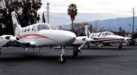 N300CG @ KRHV - Locally-based 1978 Cessna 414A Chancellor parked in front of the Lafferty Aircraft Sales hangar as the sunsets with big brother 421 Golden Eagle in the background at Reid Hillview Airport, San Jose, CA. - by Chris Leipelt
