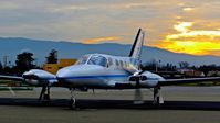 N6867L @ KRHV - Locally-based Cessna 421C preparing for taxi out and departure with a beautiful sunset at Reid Hillview Airport, San Jose, CA. - by Chris Leipelt