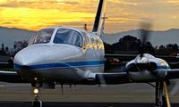 N6867L @ KRHV - Locally-based Cessna 421C preparing for taxi out and departure with a beautiful sunset in the background at Reid Hillview Airport, San Jose, CA. - by Chris Leipelt