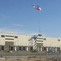 N214KK @ KTUS - N214KK lowering an HVAC unit at distribution facility roof, 1 mile NE of Tucson International Airport. - by Ehud Gavron