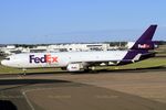 N592FE @ YSSY - TAXIING TO CARGO BAYS.  TAKEN THRU THE GLASS OF DEPARTURES LOUNGE - by Bill Mallinson