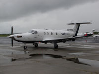 N819SA @ KAPC - SURF AIR 2014 Pilatus PC-12/47E with airstair closed waiting on GA ramp @ rainy Napa County Airport, CA for return flight to KHHR - by Steve Nation