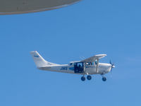 ZK-JMS @ NZWF - Taken from ZK-PBY out of Wanaka, after the Saturday airshow. There are 3 photographers in the back of JMS shooting the Catalina. Wingtip float of PBY visible top left. - by alanh