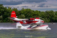N600ZE @ 96WI - Grumman Goose N600ZE on the takeoff run past Coulson Flying Tankers Martin Mars at the EAA Seaplane Base in Oshkosh, WI - by Greg Drawbaugh