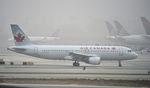 C-GQCA @ KLAX - Taxiing at LAX on a foggy morning - by Todd Royer