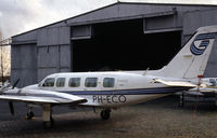 PH-ECO @ EHRD - Piper PA-31-350 Navajo Chieftains of Geosens behind a hangar at Rotterdam Zestienhoven airport, the Netherlands, 1983 - by Van Propeller