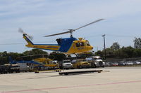 N212VC @ CMA - 1975 Bell 212 Twin Two-Twelve, one 1,800 sHp derated to 1,290 sHp PT6T-3 or one PT6T-3B Turbo Twin Pac comprising 2 coupled PT-6 TSs driving both rotors main & tail. Sheriffs #9  landing on roller pad near their Hangar. - by Doug Robertson