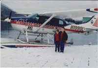 N1990L @ PSG - Tom Casey went around the world with this float plane (Notice all the country decals on the side of it) On his last leg, he made a stop in Petersburg, AK in December 1990. Our 2 boys, Brad and David, had to go check it out. - by Lynn Callaway