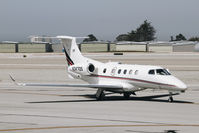 N347QS @ KMRY - Net Jets Phenom 300 taxing out for departure at Monterey Regional Airport. Not a Citation Ultra. - by Chris Leipelt