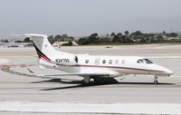 N347QS @ KMRY - Net Jets Phenom 300 taxing out for departure at Monterey Regional Airport. Not a Citation Ultra. - by Chris Leipelt