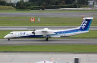 JA854A @ RJOO - ANA Q400 taxying for departure in ITM - by FerryPNL