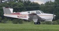 N2102D @ X04 - 1953 Bonanza V-Tail  White with red and gold stripes. - by Kenny Long