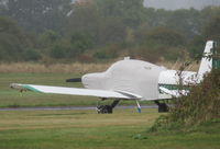 G-BDLO @ EGTR - Grumann Cheetah parked and fully covered at Elstree in the rain - by Chris Holtby