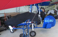 G-CDVJ @ EGTN - Gyrocopter covered up in the hangar at Enstone Airfield Oxon. - by Chris Holtby