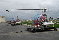 N4738R @ KSNS - Gomes Farm Air Service ramp with Bell 47G-5 sprayers N4738R, N7914S and N7938J on trailers - by Steve Nation