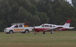 G-BYYO @ EGSG - Pilot alerted EGSG control tower to a possible landing gear problem but landed safely escorted by the airfield rescue service vehicle. - by Chris Holtby
