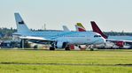 555 @ EGHH - Arriving on 26 past the parked European Cargo A340s - by John Coates