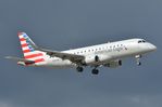 N276NN @ KMIA - Amerircan Eagle ERJ175 landing while heavy clouds arrive over the airport - by FerryPNL