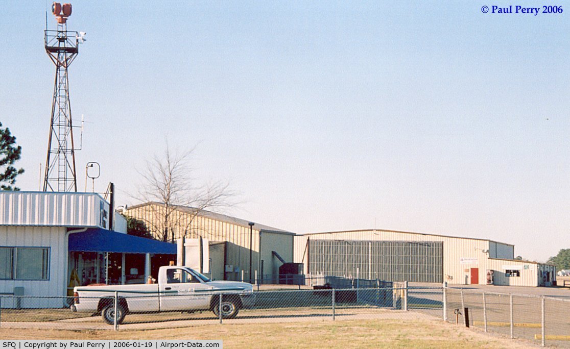 Suffolk Executive Airport (SFQ) - Back of the admin building, with one of the warbird hangers in the back