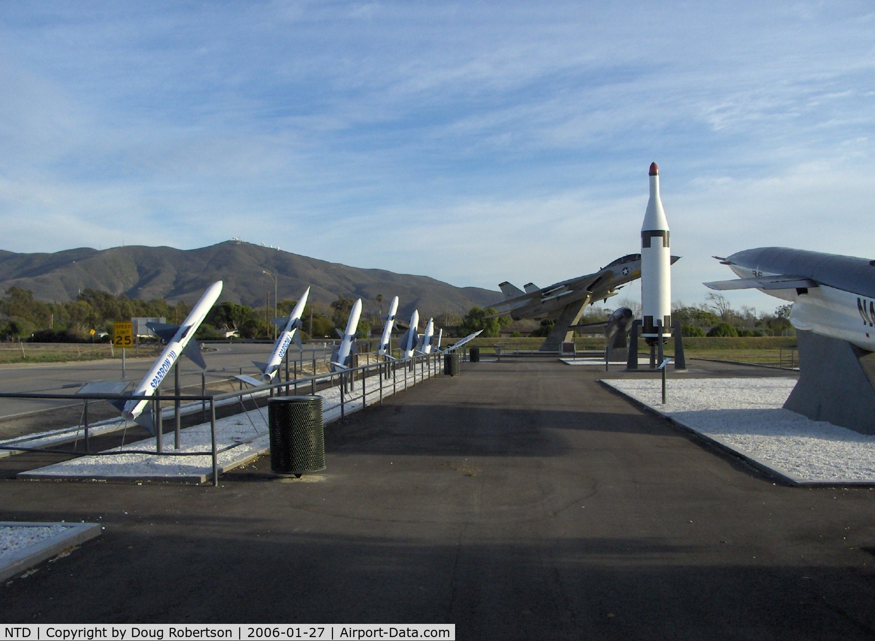 Point Mugu Nas (naval Base Ventura Co) Airport (NTD) - Missile Park, mounted F-14A TOMCAT BuNo.158623, tall vertical POLARIS, Point Mugu housing and 1,567 ft. instrumented Laguna Peak in background