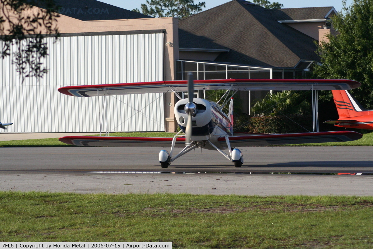 Spruce Creek Airport (7FL6) - Bi plane with private hangars in background