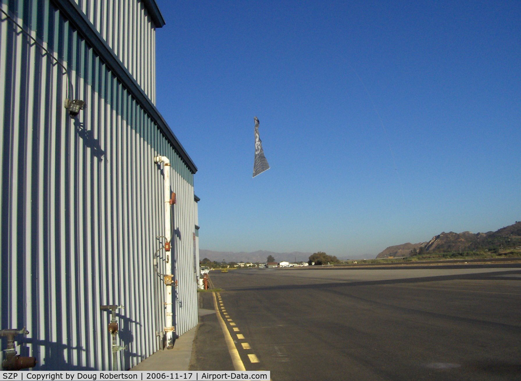 Santa Paula Airport (SZP) - Banner Tow Release/Drop over taxiway by N3042M Piper Super Cruiser with 180 Hp, Note the taxying aircraft-usually the drop is on other side of Runway 22