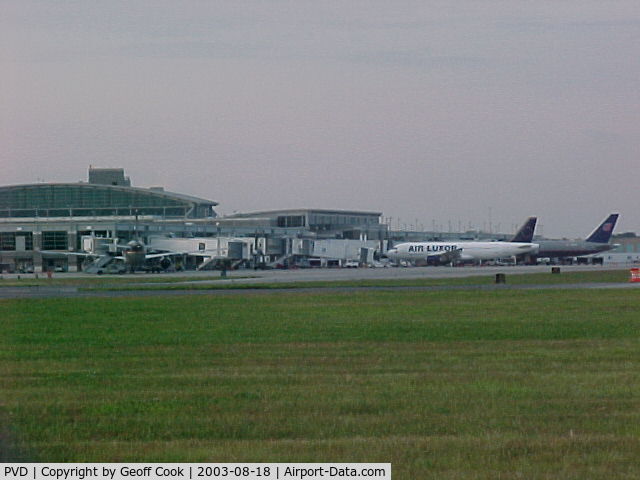 Theodore Francis Green State Airport (PVD) - The unusual sight of a an Air Luxor A320 next to a United 757 at the terminal in Providence