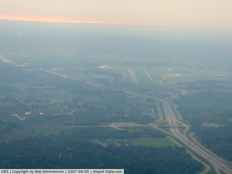 Waukesha County Airport (UES) - Looking east from 2500' with Lake Michigan reflecting the morning sun in the distance.