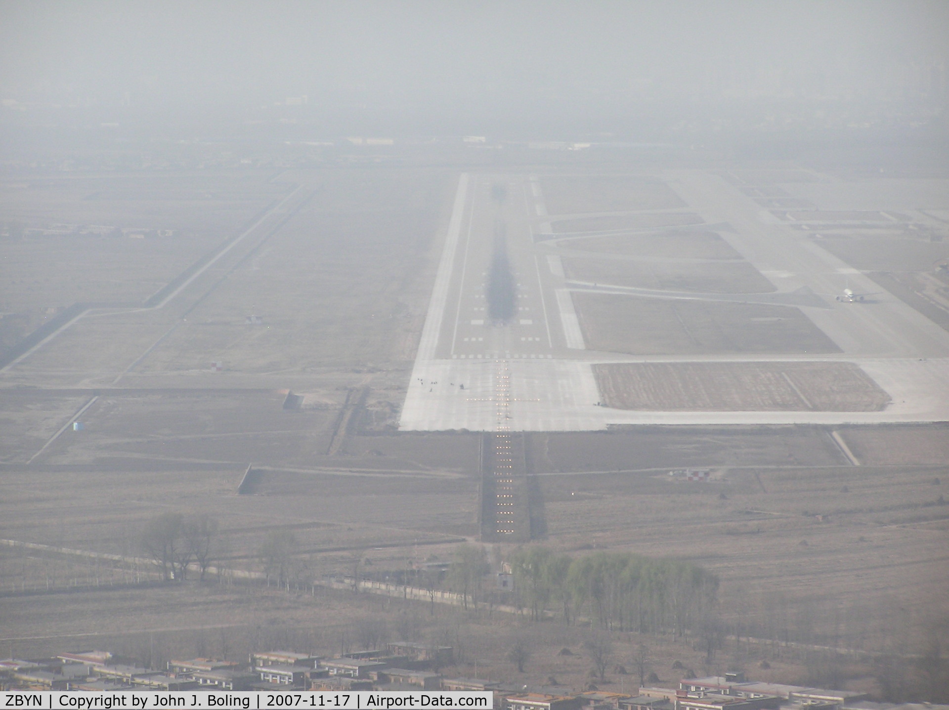 Taiyuan Wusu Airport, Taiyuan, Shanxi China (ZBYN) - Runway 31 at Taiyuan PRC, ZBYN/TYN. Haze/smog keeps vis low.