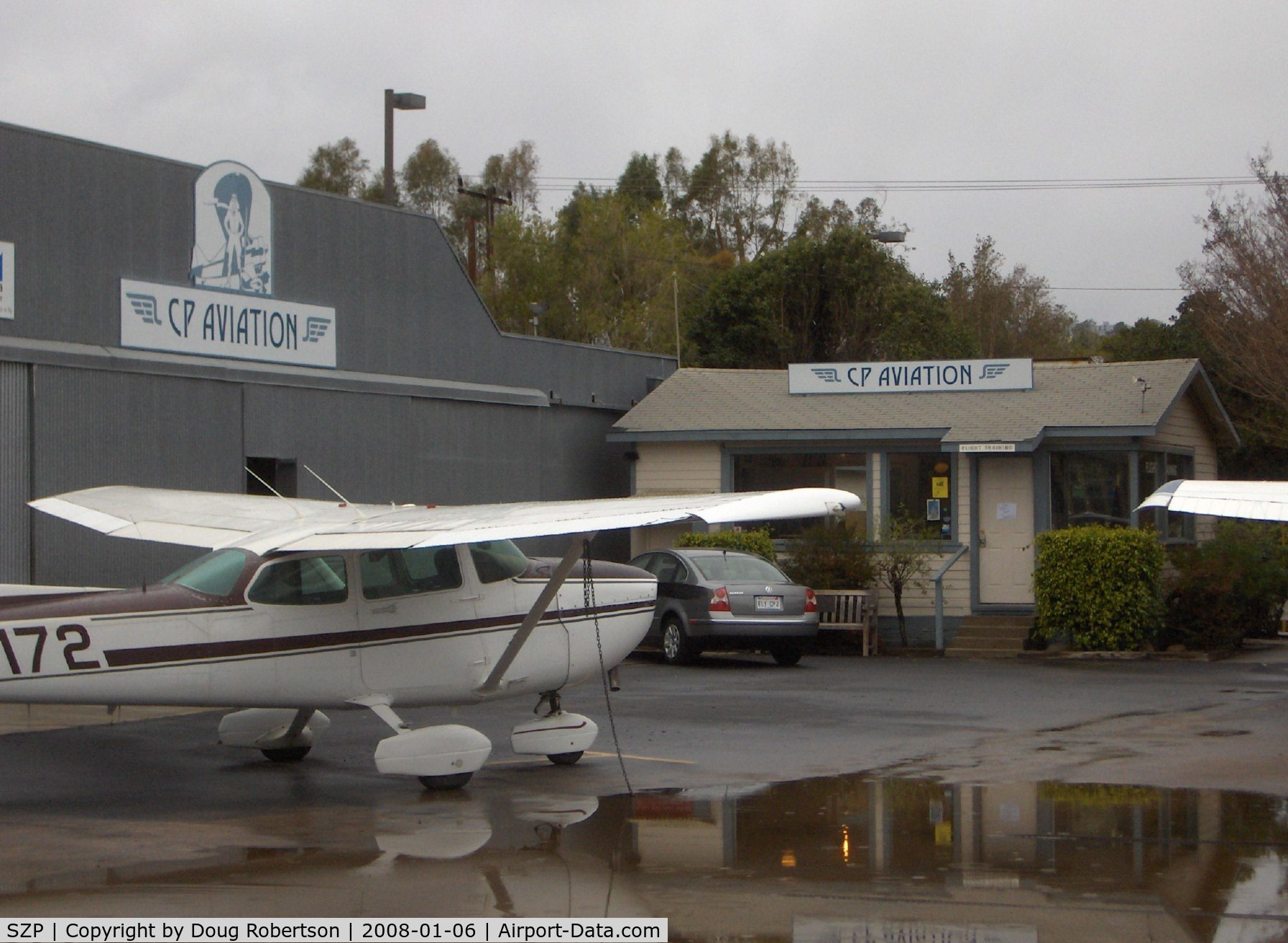 Santa Paula Airport (SZP) - CP Aviation, FBO offering flight instruction and aircraft maintenance. Hangar and Office. Part of CP's extensive flight line of aircraft on a rare, rainy day.