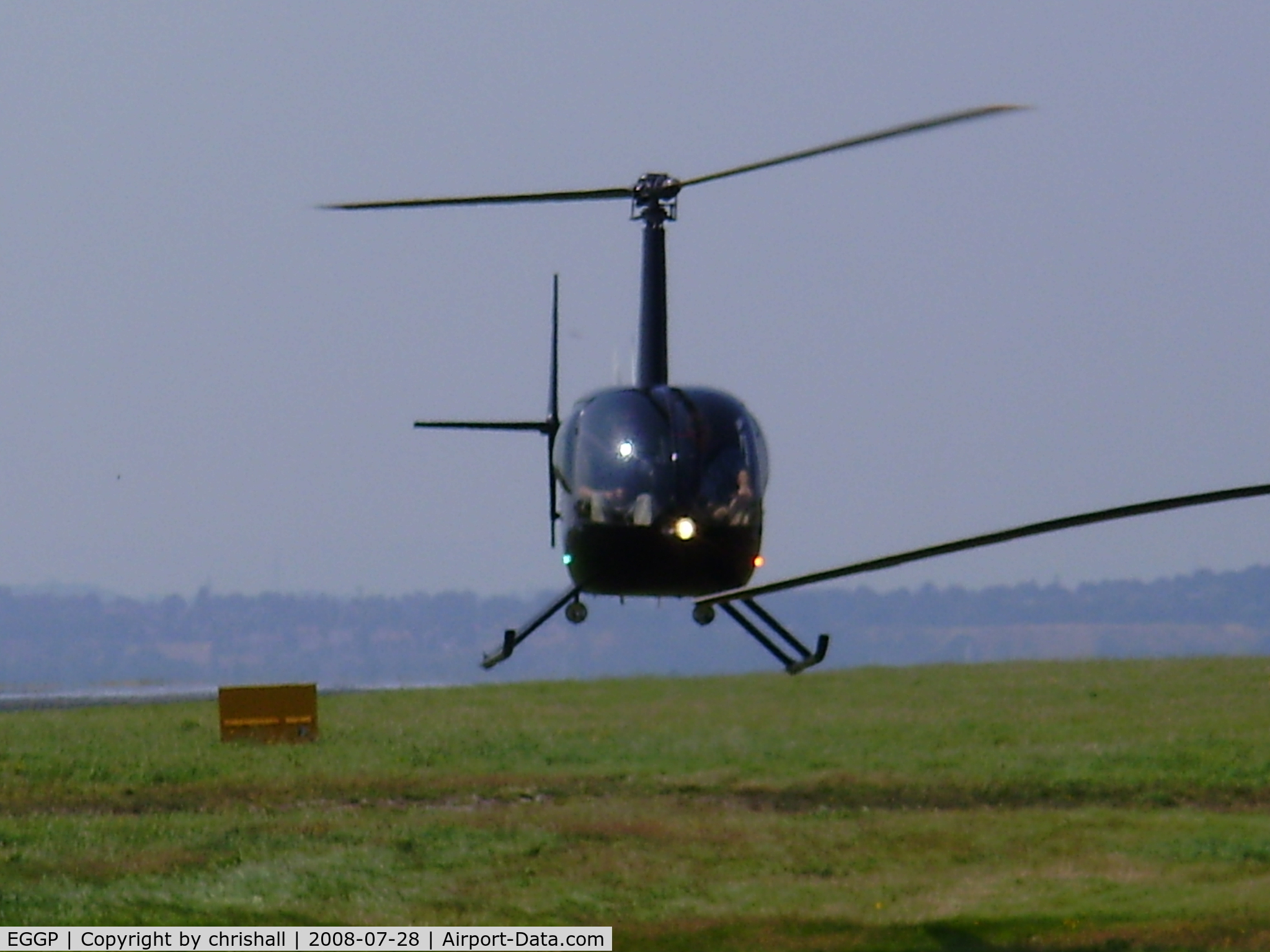 Liverpool John Lennon Airport, Liverpool, England United Kingdom (EGGP) - Robinson R22 hovering near the GA apron