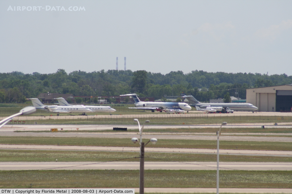 Detroit Metropolitan Wayne County Airport (DTW) - Looking across Runways 3R/21L and 3L/21R at an ex Spirit MD80, Detroit Pistons DC-9 and several private jets