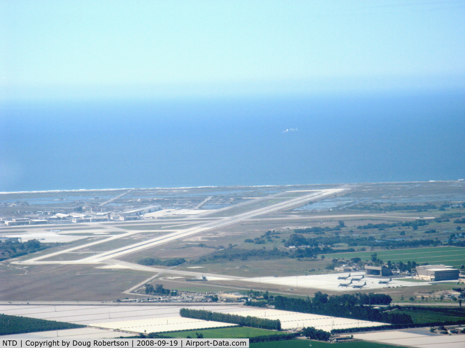 Point Mugu Nas (naval Base Ventura Co) Airport (NTD) - Naval Air Warfare Station, Point Mugu, California. Pacific Ocean beyond. Lower right portion shows Channel Islands Air National Guard taxiway and ramp who shares Pt. Mugu's two runways. Taken from RV-6 N406L.