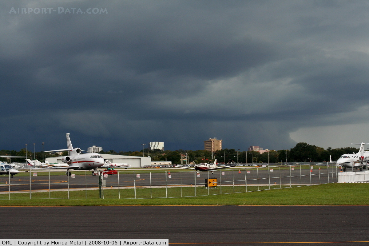 Executive Airport (ORL) - Orlando Executive Airport with Downtown Orlando and storm in background