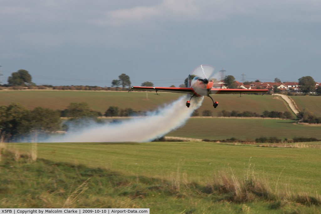 X5FB Airport - Extra G-ZXEL takes off from Fishburn's 6 degree upslope making smoke.
