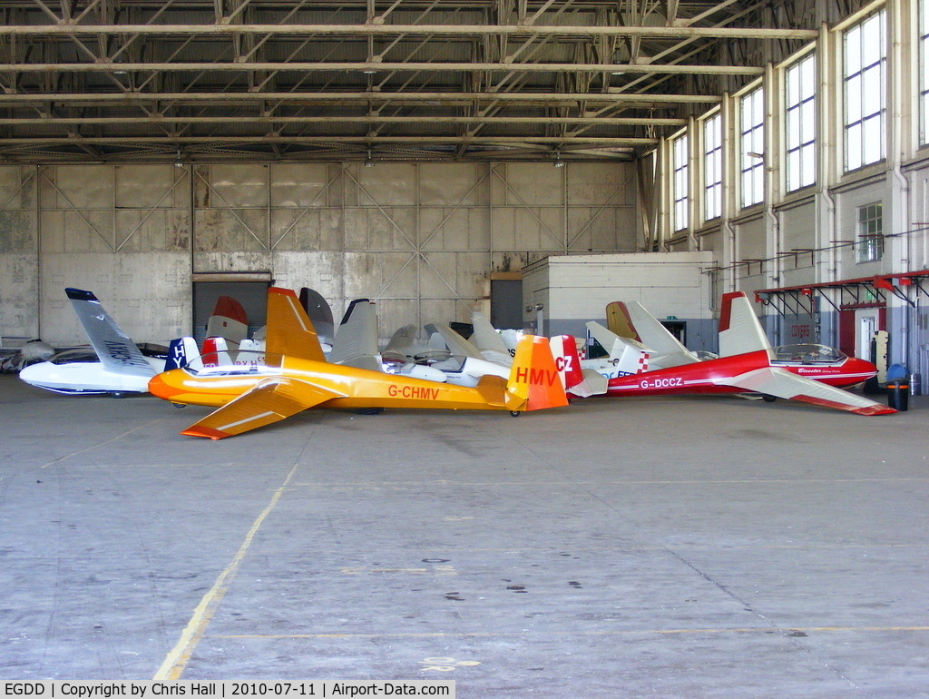 EGDD Airport - Gliders inside one of the C-Type hangars at former RAF Bicester, now the home of The Windrushers Gliding Club and Oxford University Gliding Club
