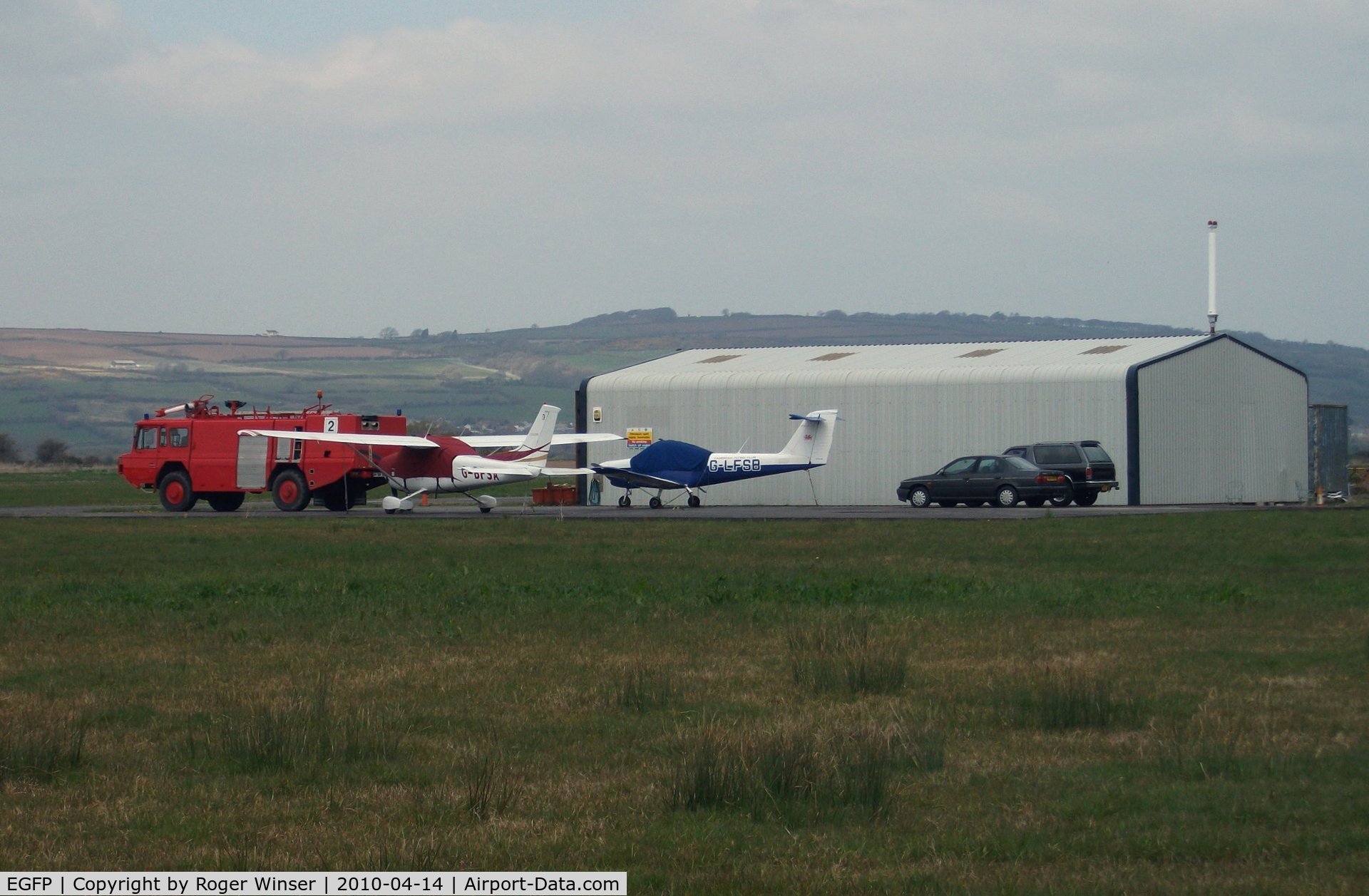 Pembrey Airport, Pembrey, Wales United Kingdom (EGFP) - Pembrey Airport hangar, resident aircraft and Fire and Rescue tender FIRE 2. 