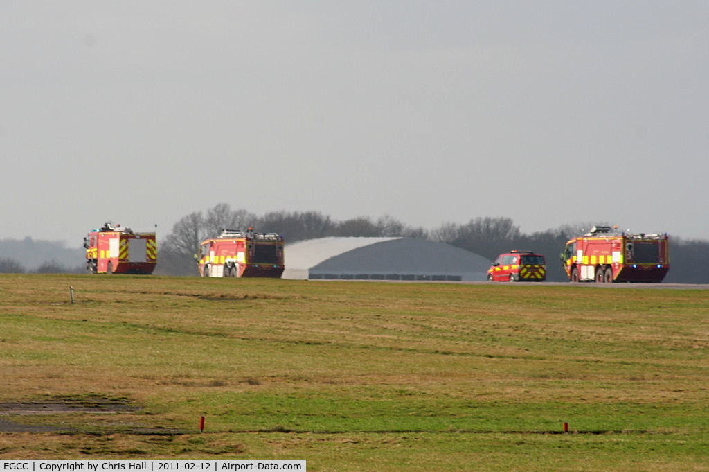 Manchester Airport, Manchester, England United Kingdom (EGCC) - Fire trucks racing down the runway after Thomas Cook B767 G-DAJC, which made an emergency landing with a problem with its flaps