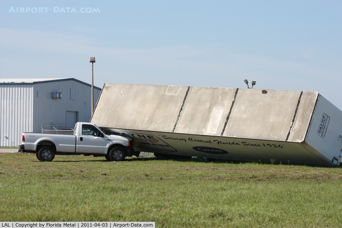 Lakeland Linder Regional Airport (LAL) - Storm damage from the 3/30/11 microburst/tornado.  Trailer blown down onto a Ford F250