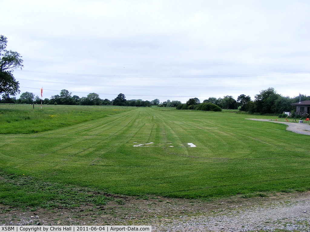 X5BM Airport - view down RW23 at Baxby Manor, note the High voltage transmission lines that pass over the runway